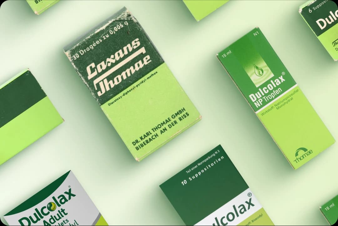 Various packages of medical products, including "Laxans Thomae" and "Dulcolax NP Tropfen."